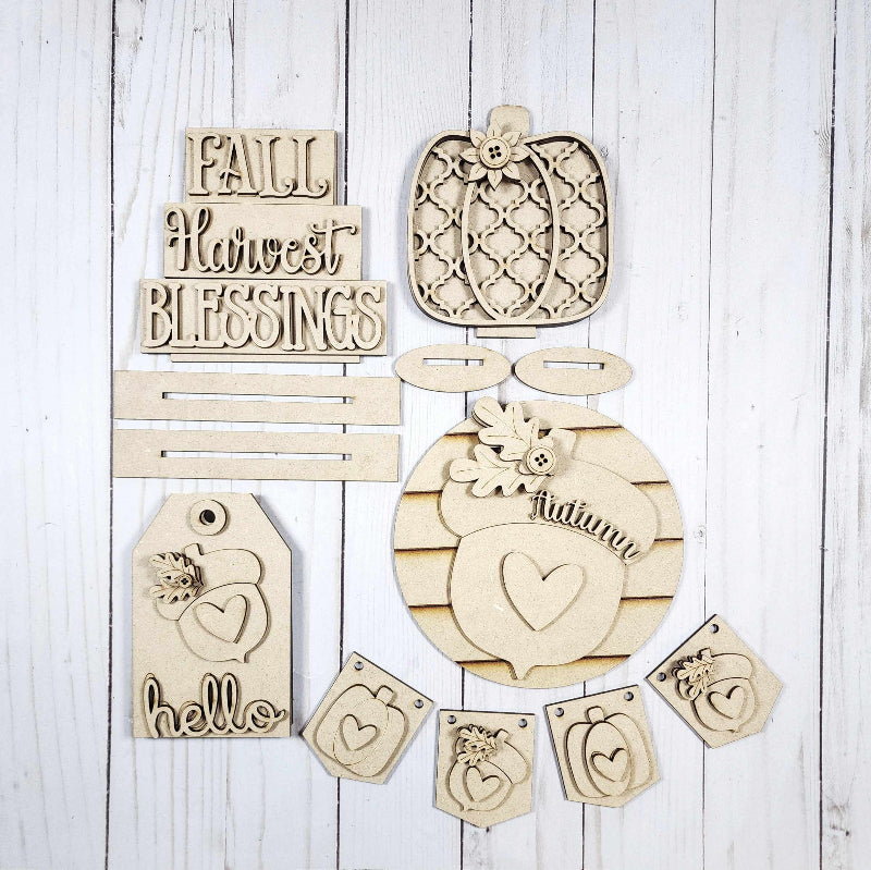 Set of wooden decorative pieces with text and patterns on a white wooden background