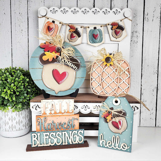 Decorative signs with autumn-themed phrases on a wooden stand against a white wooden panel background.